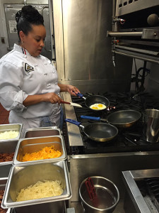EGG-CELLENT SERVICE: A Culinary Arts student, above, prepares hot and fresh orders for The Student Chef restaurant. PHOTO BY MIDORI MORITA