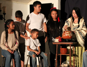 Marie Cobian, bottom, performs with Camacho’s fictional family on stage. PHOTO BY ORLANDO JOSE
