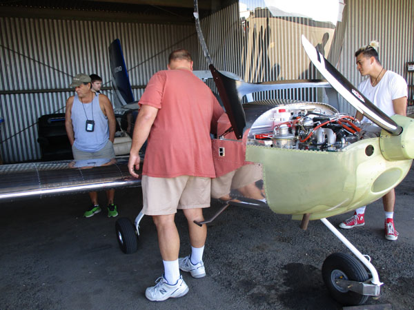 Delta students examine airplane's engine and internal functions at the Stockton Airport.