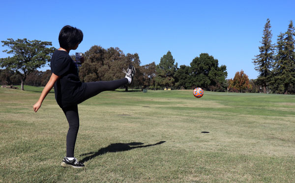 Opinion Editor Vivienne Aguilar kicks the ball down the fairway.