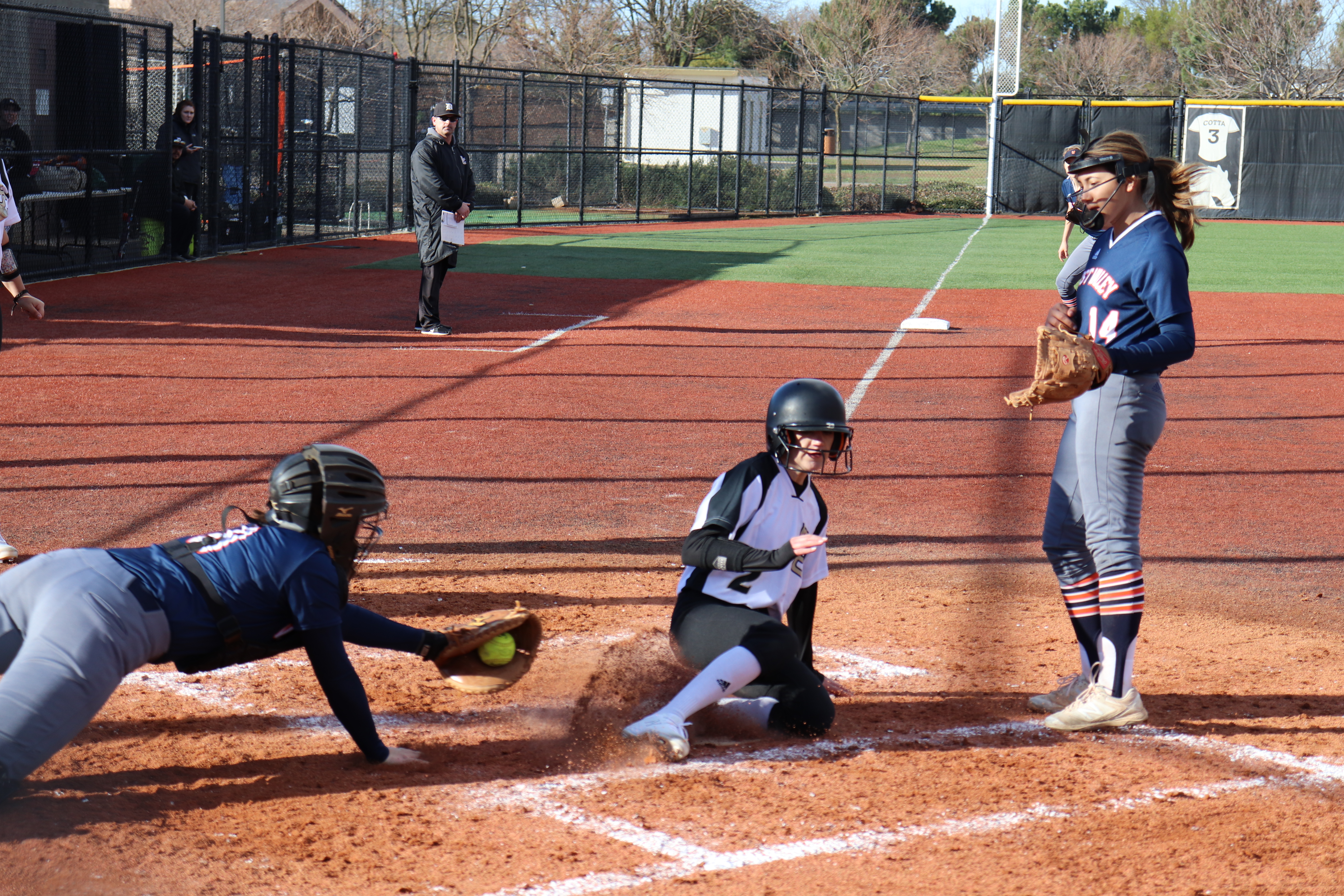 Morgan Wheeler slides safely into home to score a run. Photo by Paul Muyskens