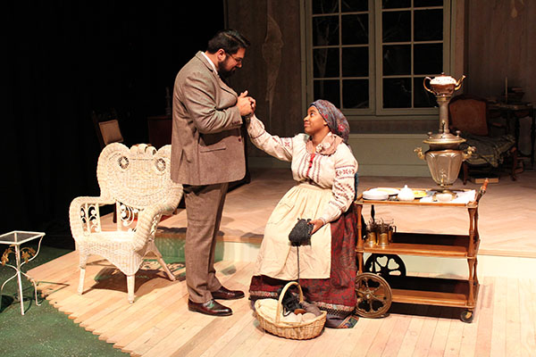 Navaz Khan as Astrov (left) and Imri M. Tate as Marina (right) in Delta Drama’s production of Uncle Vanya during rehearsal on Feb 24 in the Al Muller Studio Theater. This scene opens the play. Photo by Vivienne Aguilar