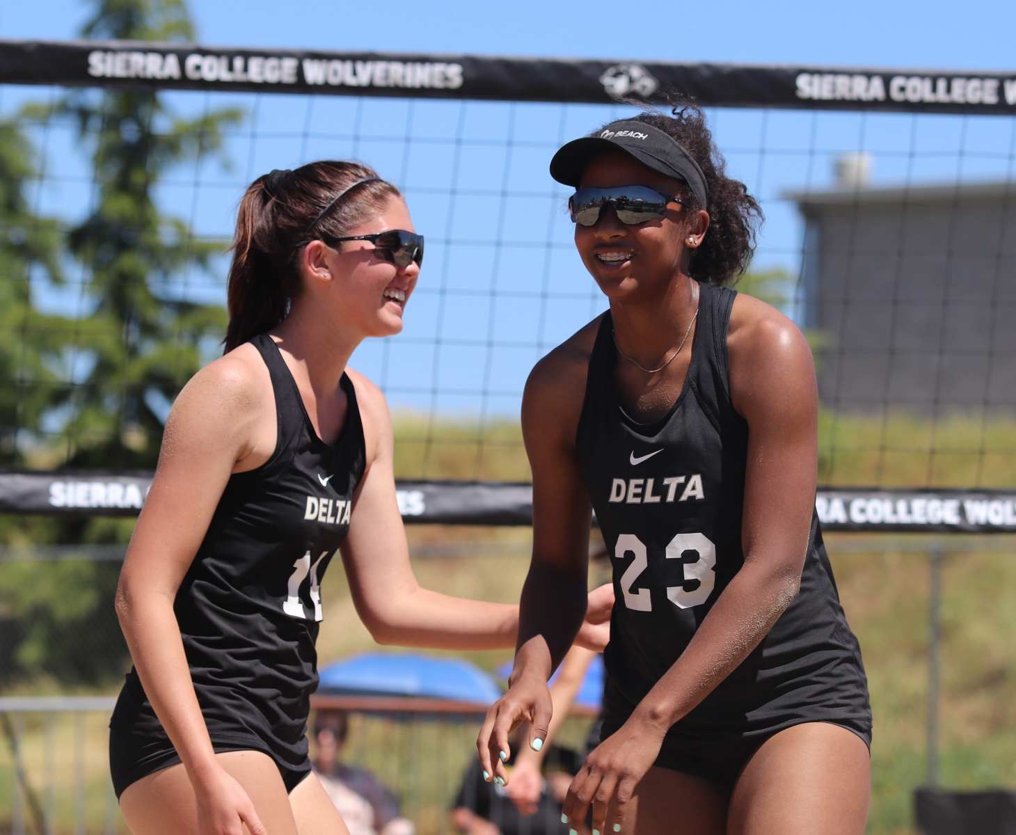 Kelly Markham and Amilya Thompson celebrate after scoring a point. The pair would eventually qualify for the state finals.