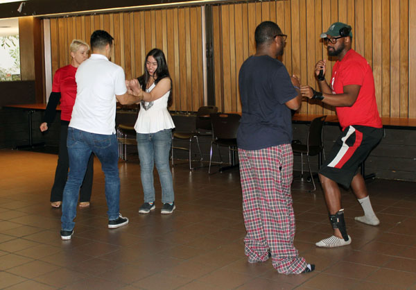 Byrd guiding students through how to attack quickly right after getting free from a wrist hold.