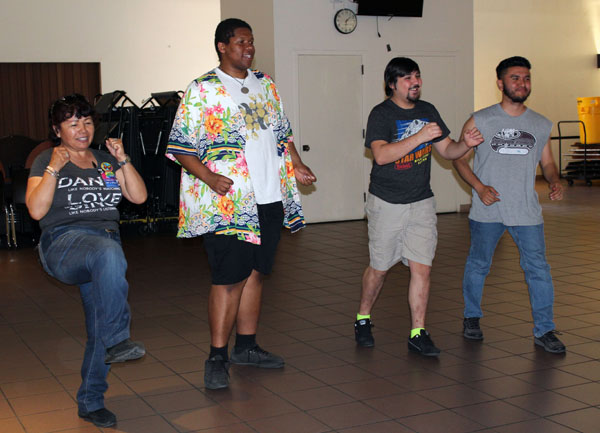 Students practicing their kicking with proper form.