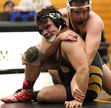 Ron Mendoza wrestles in the final match of the dual meet against Sacramento City. Photo by Paul Muyskens