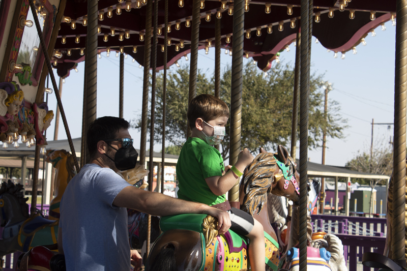 Father and son on new carousel at Dell’osso Family Farm. PHOTO BY JAHDAI SPIKES
