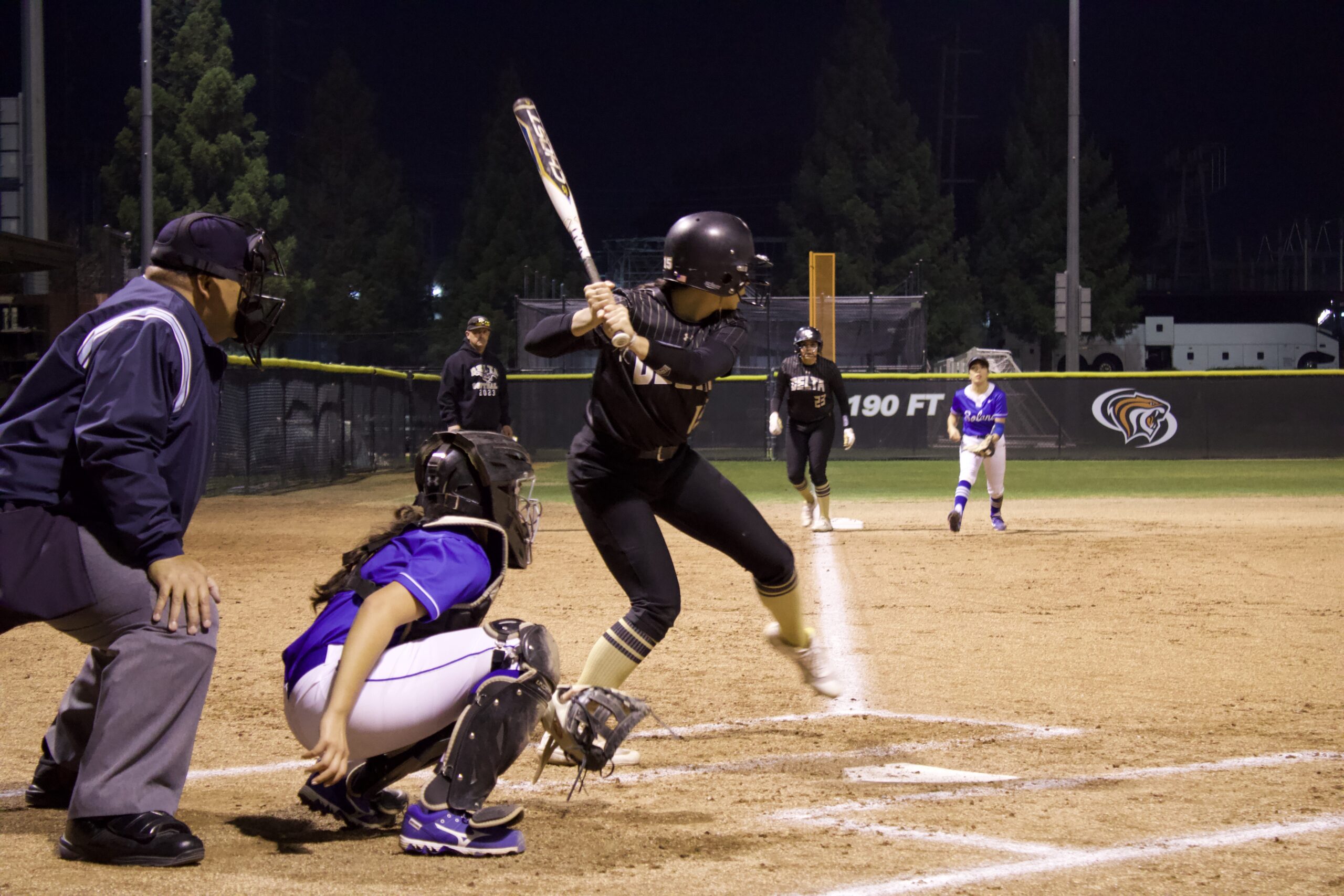 Above: Mustangs utility athlete Alle Perea prepares to hit the ball from the batter box while outfield Danyelle Godoy is at third base on Feb. 9 PHOTO BY ANDREA RIVERA