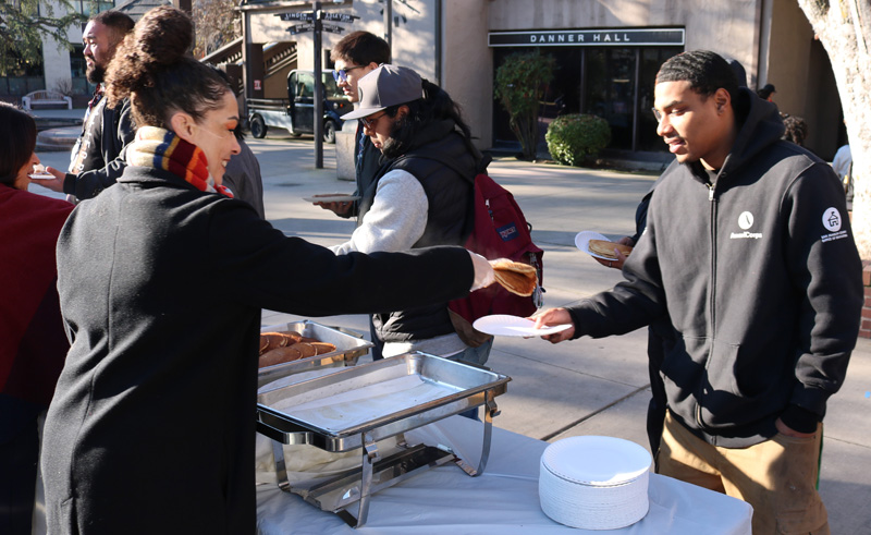 Vice President of Student Services Lonita Cordova serves pancakes to Lewis Perez at Pancakes with the President on Jan. 13, 2025. PHOTO BY LEVI GOERZEN