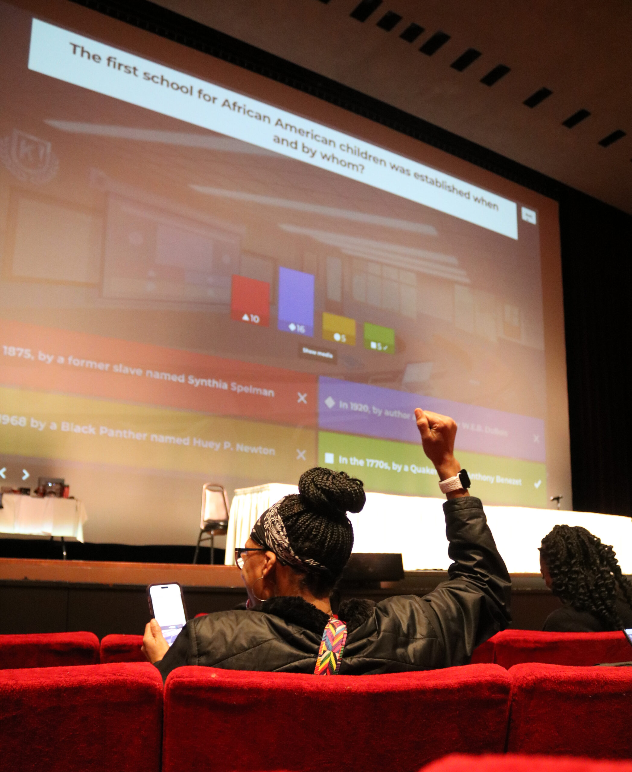 Cassandra Martin celebrating after getting a Kahoot question correct during the Black History Month Kickoff in Atherton Auditorium on February 6