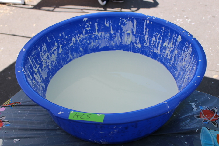 An American Chemical Society-labeled tub of oobleck dyed green at The Market at Delta. PHOTO BY JOHN NGUYEN