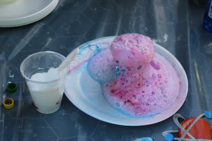 An erupted baking soda volcano on a plate next to a cup of baking soda at The Market at Delta. PHOTO BY JOHN NGUYEN