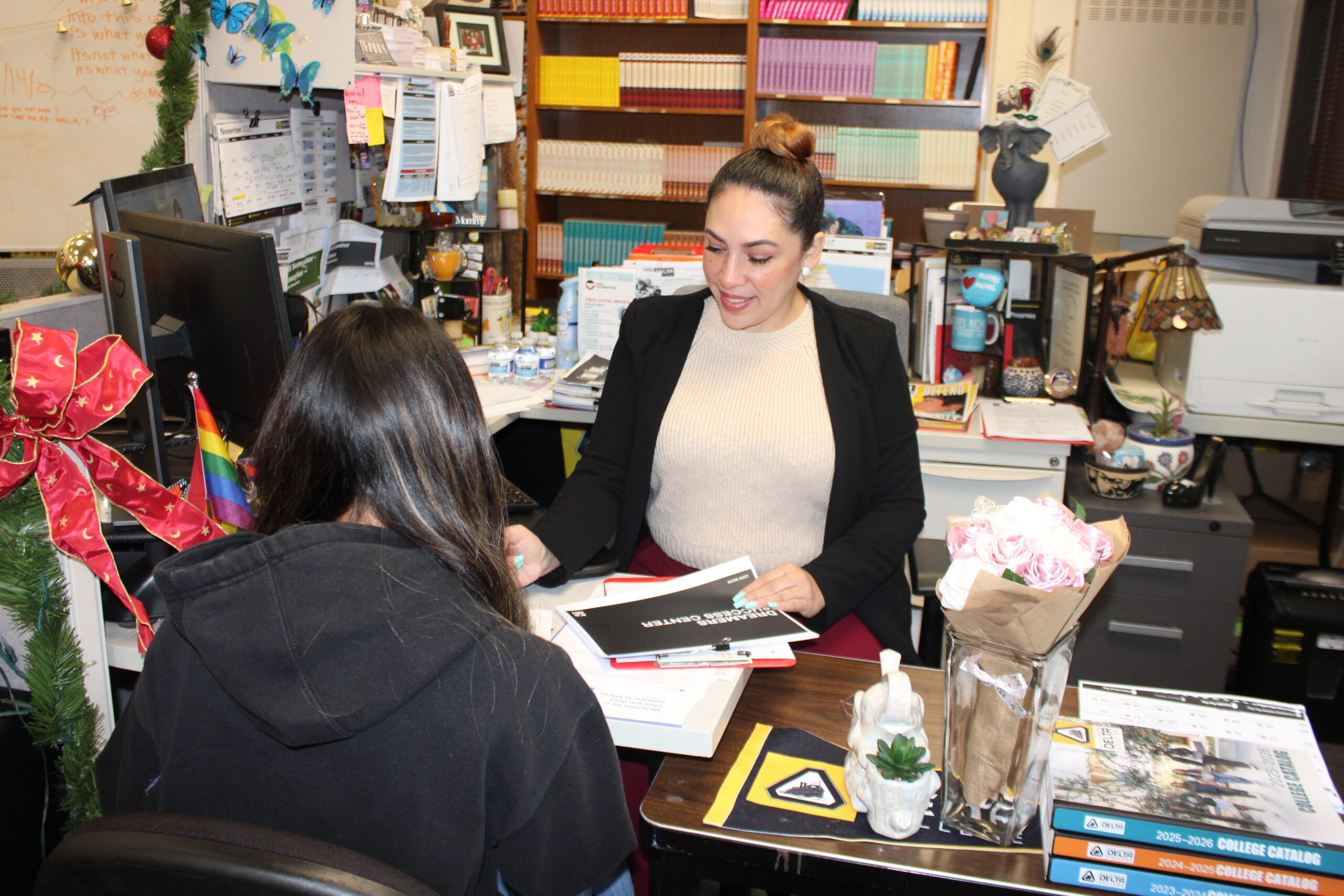 Dreamers Center Resource Specialist Tina Leal helping a student. Photo by Andrea Baltodano.