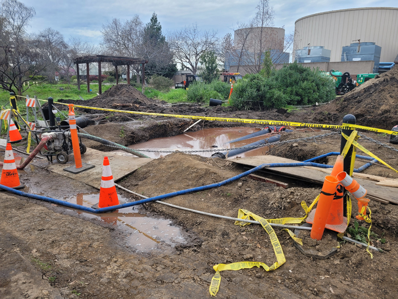 A pit dug for HVAC repairs is filled with water after a newly installed pipe began leaking on Feb. 24. PHOTO BY AZRIEL DRUMHELLER