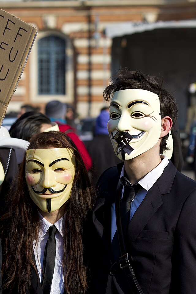 Protesters in Guy Fawkes masks rally in Toulouse