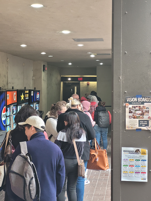Students wait for the food pantry to open. Long lines are more common now than a few semesters ago. PHOTO BY AZRIEL DRUMHELLER