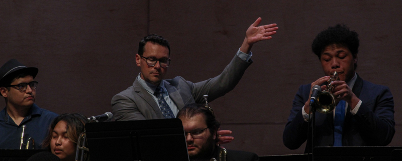 Adjunct Professor Michael Rocha showing off freshman Osi Latu during his big trumpet solo at the Jazz Percussion con- cert on Feb. 25