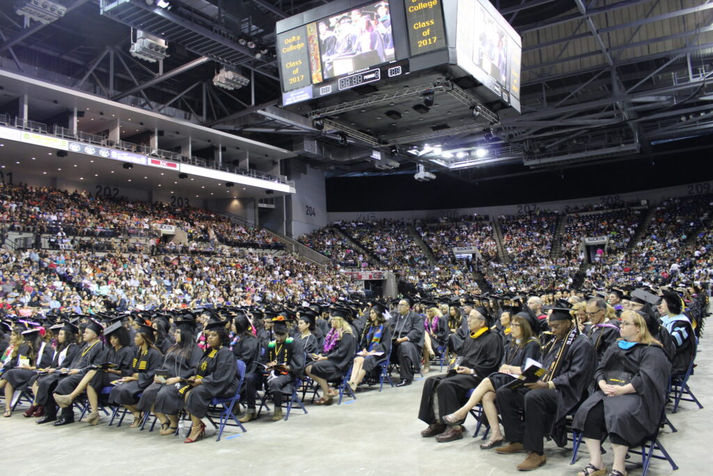 Graduates attend a San Joaquin Delta College commencement ceremony at Adventist Health Arena in Stockton