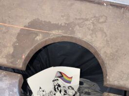 A sign LGBTQIA+ rights that had been posted in the Holt building sits in a trash can on the morning of May 1. The sign is one of several that have been removed from the Delta College campus in recent weeks. PHOTO CONTRIBUTED TO THE COLLEGIAN