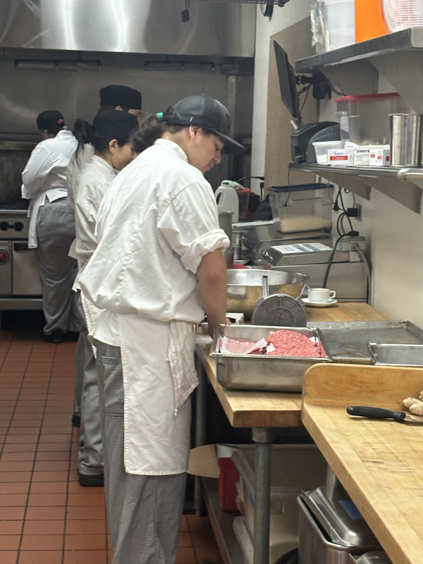Thomas Alanzo is making the burger patties for the burgers on Wednesday and Thursday when the bar grill will be open (photo taken by Jacob S Manglinong of MCOM 10)