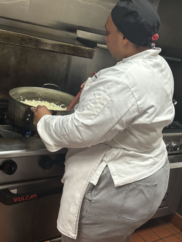 Here's a female chef caramelizing some onions in a giant pot (photo taken by Jacob S Manglinong of MCOM 10)
