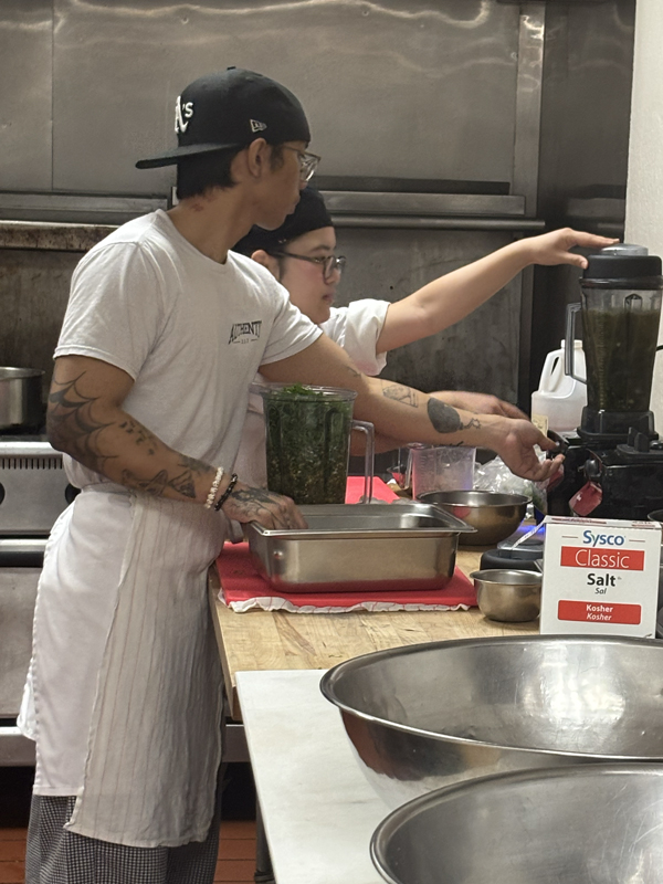 Two chefs blending something in a blender (photo taken by Jacob S Manglinong of MCOM 10)