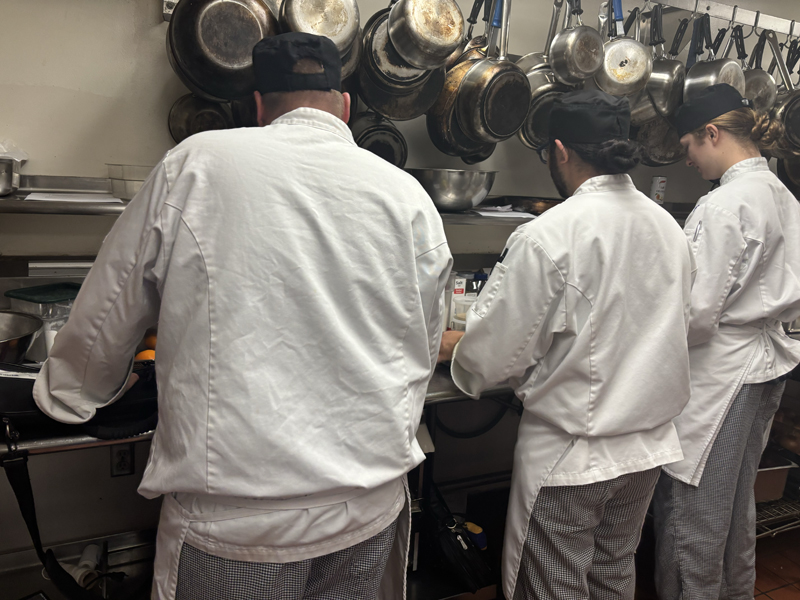 Three chefs are using what appears to be oranges (photo taken by Jacob S Manglinong of MCOM 10)
